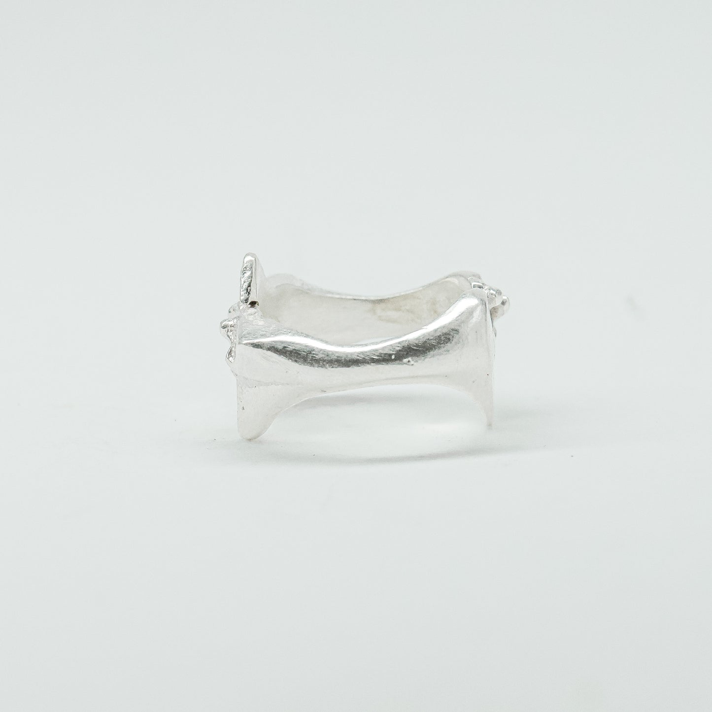 Sculptural silver ring showcasing both a heart and star form, with small gemstones set into each motif. Handmade and one of a kind.