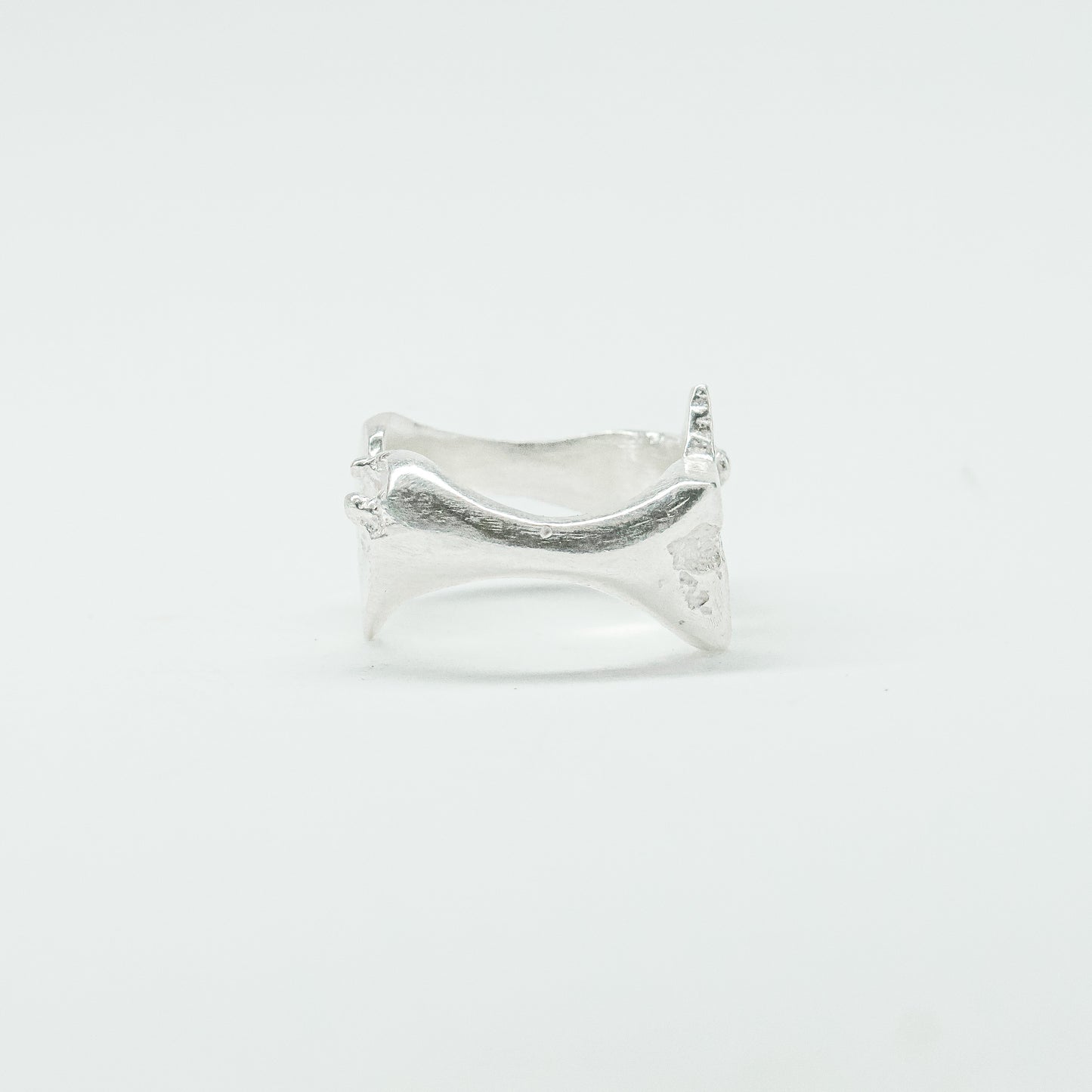 Sculptural silver ring showcasing both a heart and star form, with small gemstones set into each motif. Handmade and one of a kind.