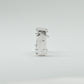 Hand-sculpted sterling silver ring with a bold, square silhouette and deep textured finish, featuring small round gemstones set into each corner.
