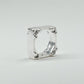 Hand-sculpted sterling silver ring with a bold, square silhouette and deep textured finish, featuring small round gemstones set into each corner.