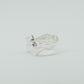 Sculptural silver ring showcasing both a heart and star form, with small gemstones set into each motif. Handmade and one of a kind.