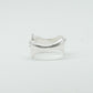 Sculptural silver ring showcasing both a heart and star form, with small gemstones set into each motif. Handmade and one of a kind.