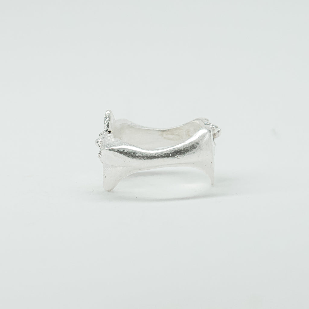 Sculptural silver ring showcasing both a heart and star form, with small gemstones set into each motif. Handmade and one of a kind.
