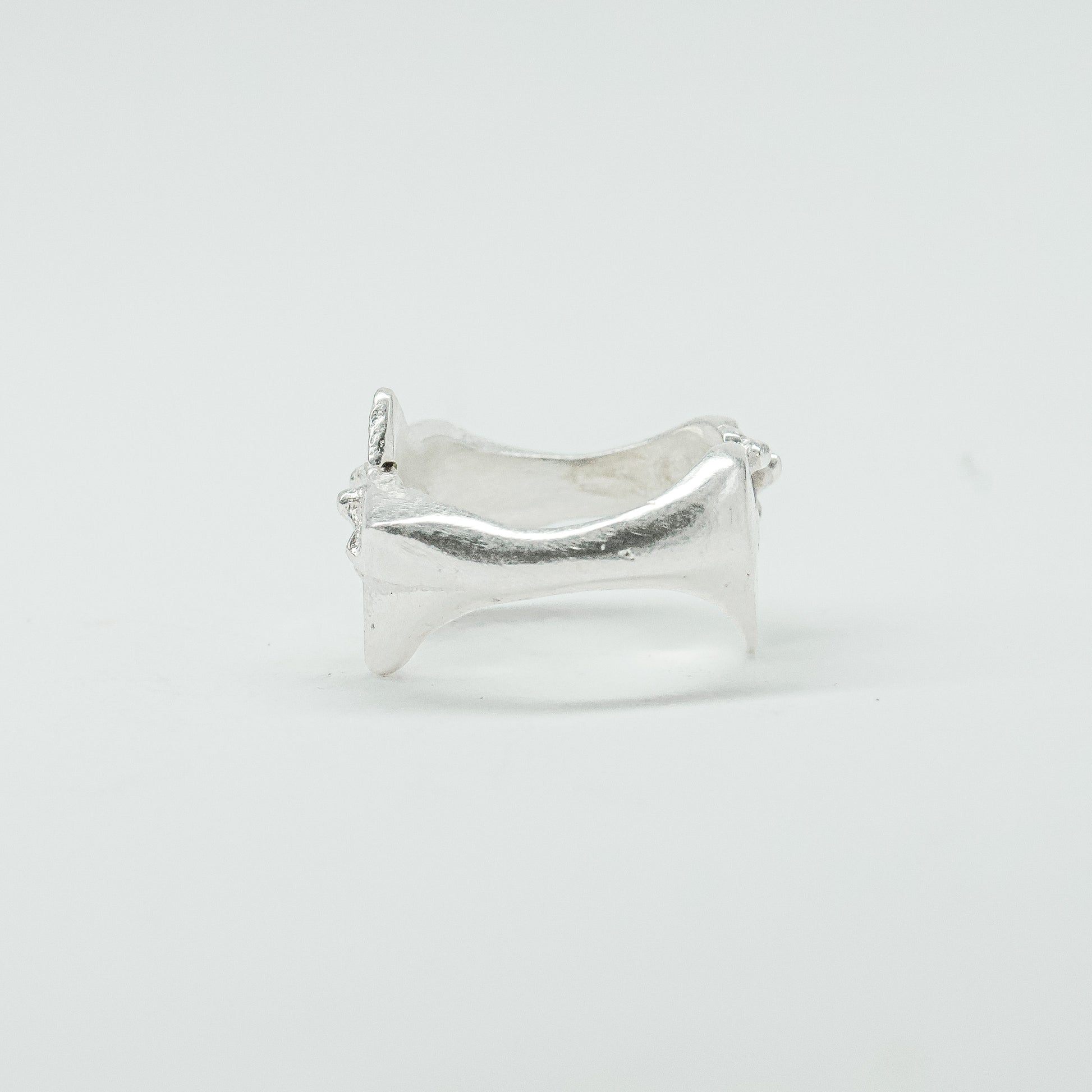 Sculptural silver ring showcasing both a heart and star form, with small gemstones set into each motif. Handmade and one of a kind.