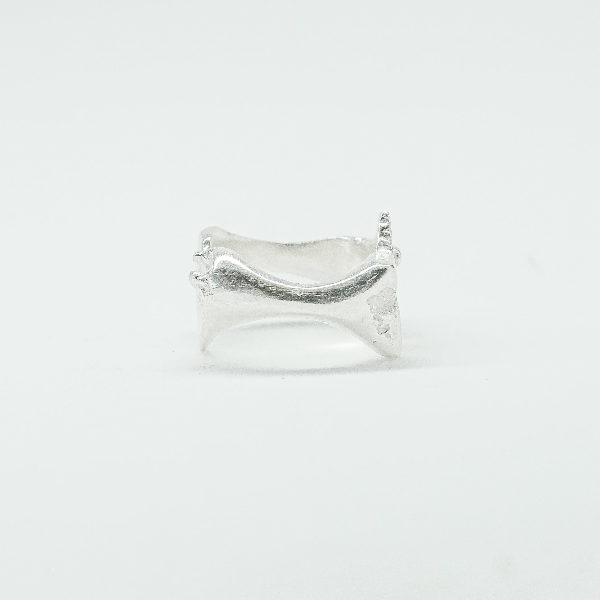 Sculptural silver ring showcasing both a heart and star form, with small gemstones set into each motif. Handmade and one of a kind.