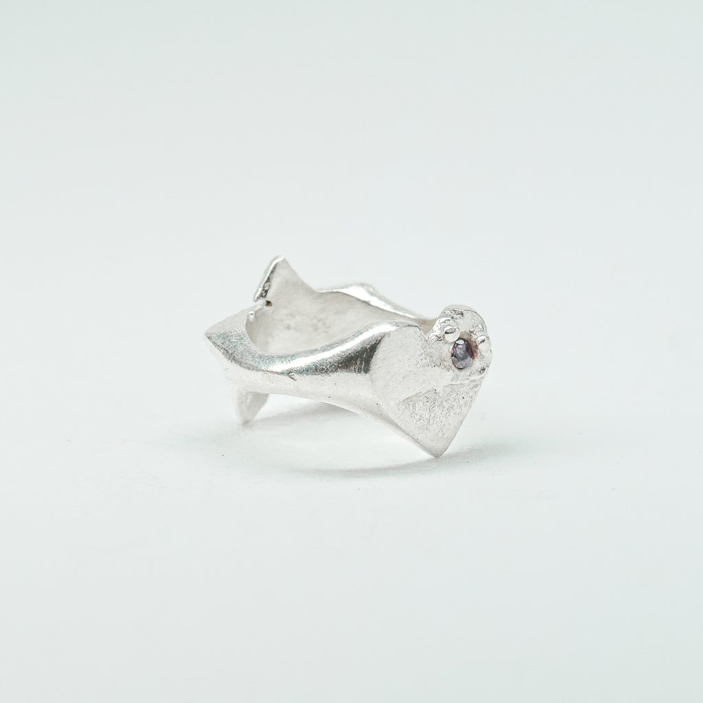 Sculptural silver ring showcasing both a heart and star form, with small gemstones set into each motif. Handmade and one of a kind.