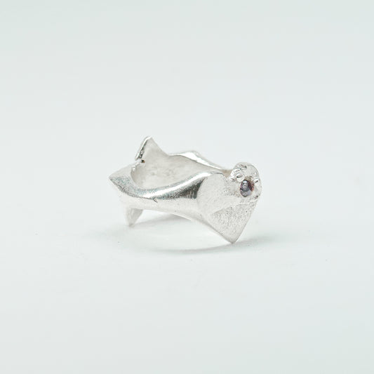 Sculptural silver ring showcasing both a heart and star form, with small gemstones set into each motif. Handmade and one of a kind.