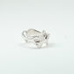 Sculptural silver ring showcasing both a heart and star form, with small gemstones set into each motif. Handmade and one of a kind.